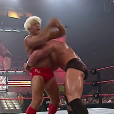 Brock Lesnar is holding Ric Flair as Ric is trying to get out.